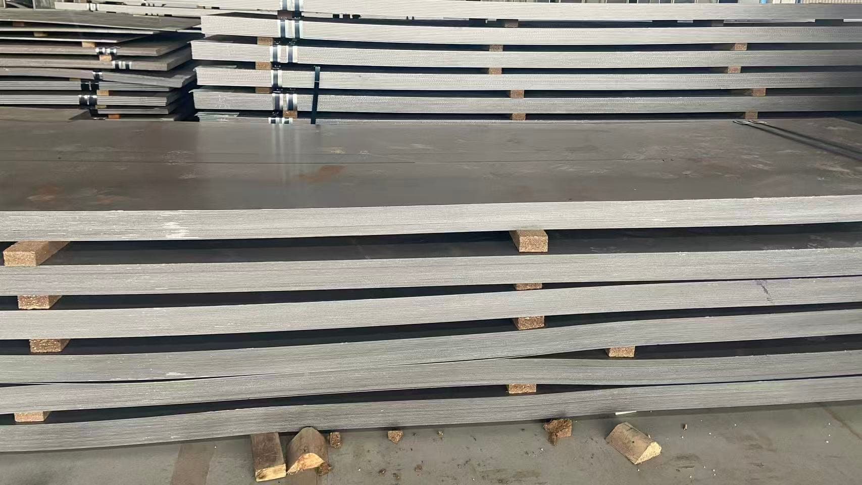 Hull structural steel plate in stock, stacked on timber dunnage, ZCMetals warehouse Wuhan