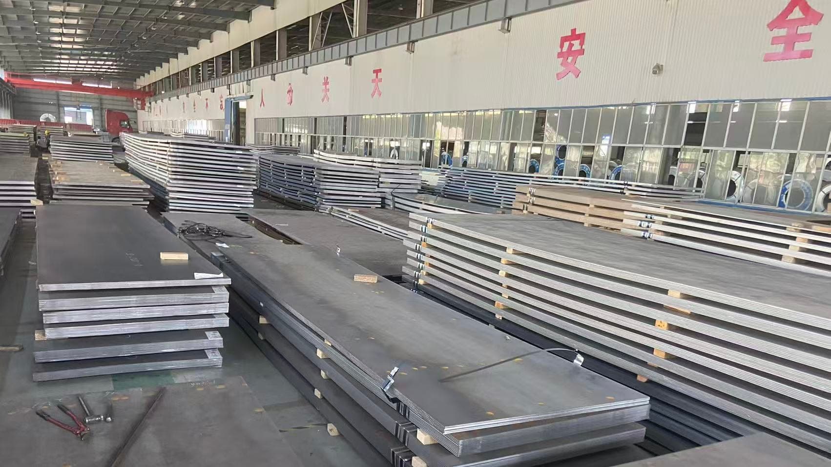 Shipbuilding steel plate stacked along the aisle of the ZCMetals warehouse in Wuhan